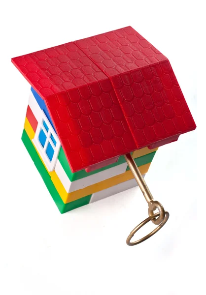 Toy house with golden key — Stock Photo, Image