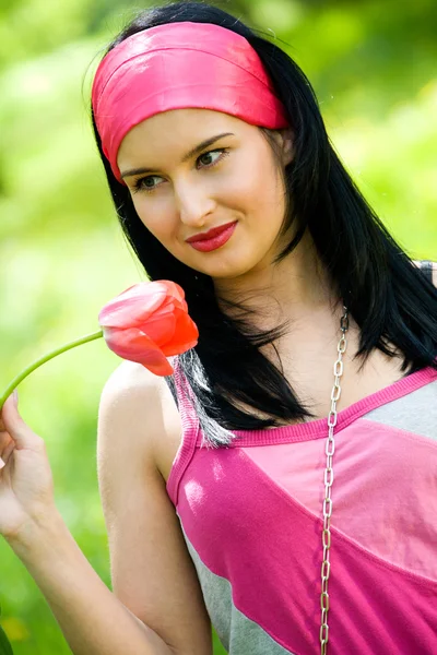 Sexy brunette with red tulip — Stock Photo, Image