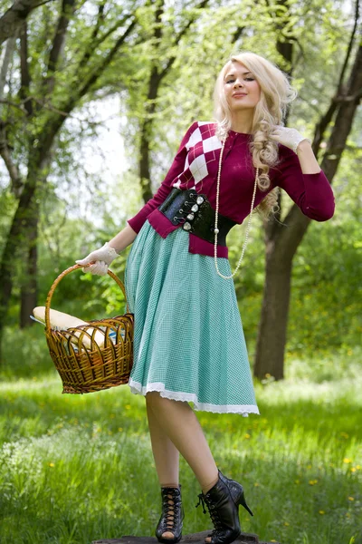 Belle jeune blonde avec panier dans le parc d'été — Photo