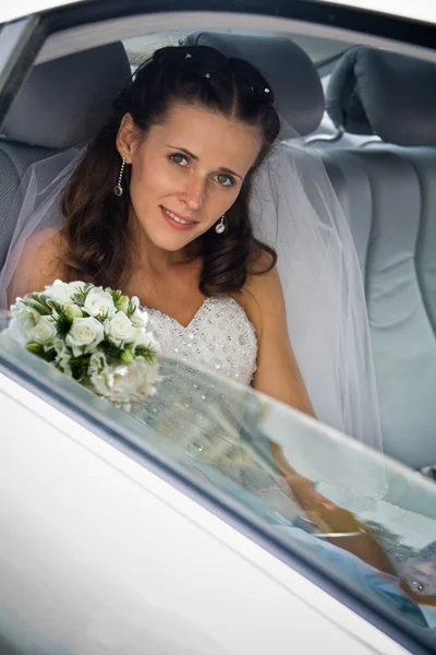 Bride inside the wedding car Royalty Free Stock Images