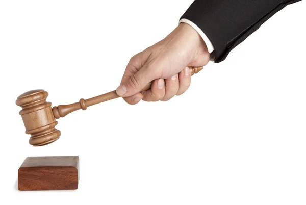 Human hand holding a wooden gavel isolated — Stock Photo, Image