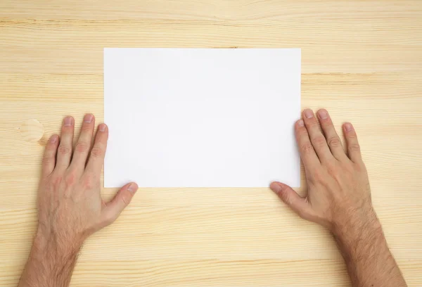 Human hand holds a blank paper — Stock Photo, Image