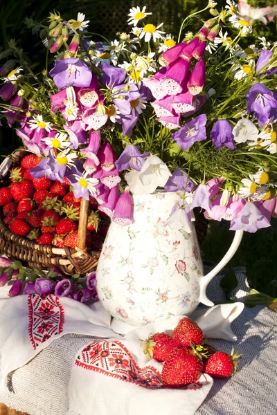 stock image Strawberries and bouquet of flowers