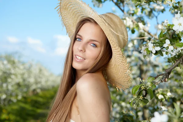 Portret van jonge mooie vrouw in Lentebloemen over geweldige ga — Stockfoto