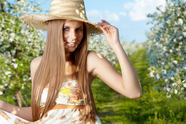 Portrait of young lovely woman in spring flowers over amazing ga — Stock Photo, Image