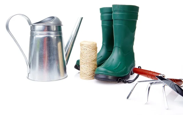 Garden boots with tool and watering — Stock Photo, Image