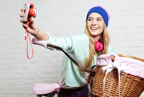 Ung kvinna fotografera en cykel innan shopping年轻女子在购物前拍摄一辆自行车 — Stockfoto