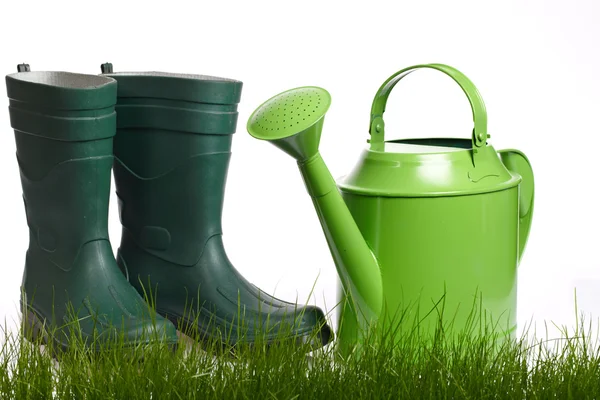 Spring gardening - Watering can, grass and garden tools on white — Stock Photo, Image
