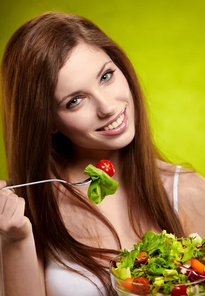 Happy healthy woman with salad on green background — Stock Photo, Image