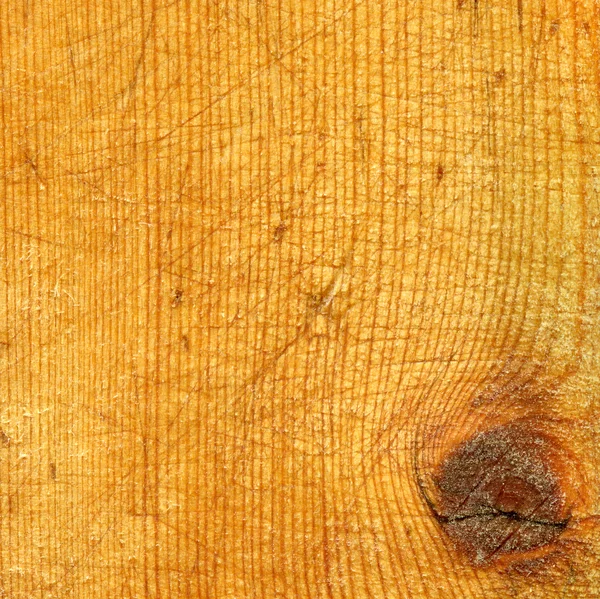 Um fragmento de uma velha tábua de corte de madeira — Fotografia de Stock