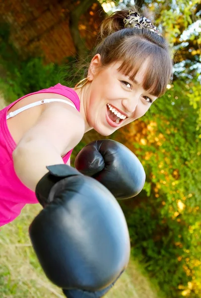 Merry girl in boxing-gloves — Stock Photo, Image