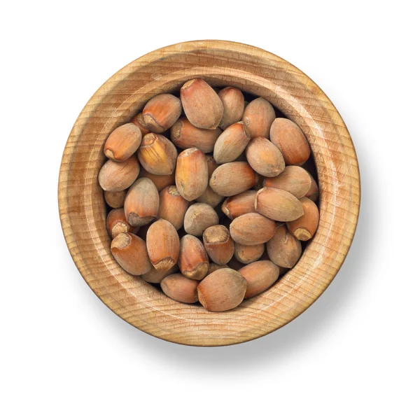Hasselnötter i trä plattan — Stockfoto