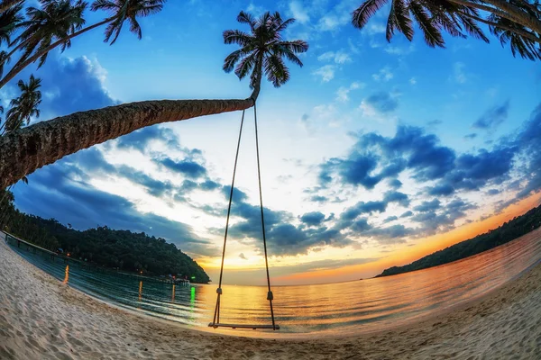 Swing op zonsondergang op het strand — Stockfoto