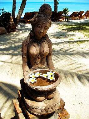 Statue of woman on the beach. clipart