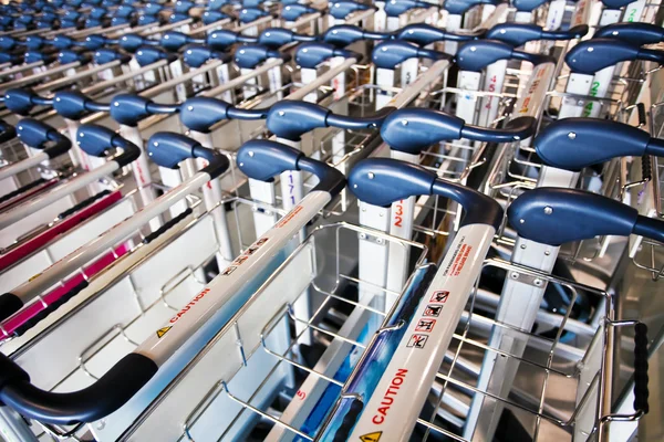 stock image Row of luggage carts