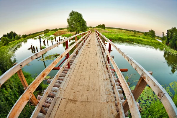 Stock image Wooden bridge over the small river