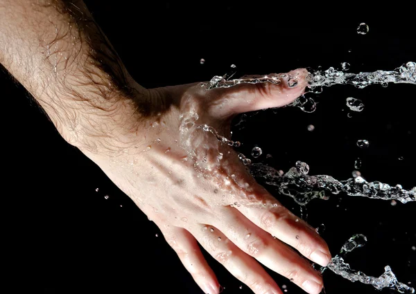 Hand and splashing water — Stock Photo, Image