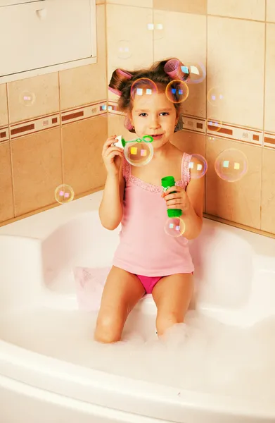 Little girl blow bubbles in the bathtub — Stock Photo, Image