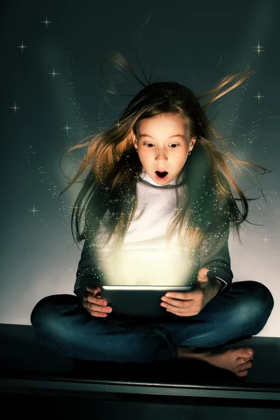 Surprised girl with tablets in hand — Stock Photo, Image