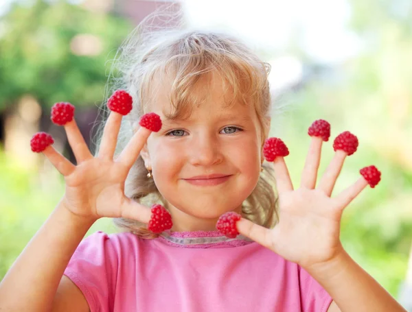 Little girl with raspberry — Stock Photo, Image