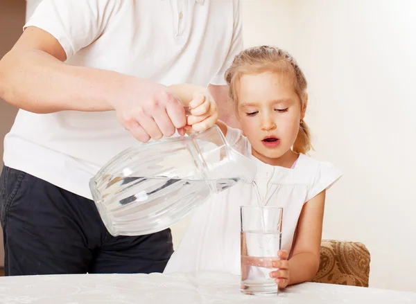 Ребенок со стеклянной питчерской водой — стоковое фото