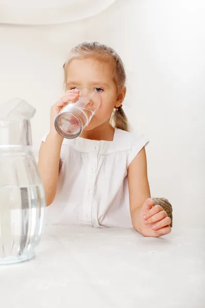 Child with glass pitcher water — Stock Photo, Image