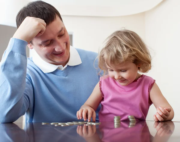Dad and daughter puts coins — Stock Photo, Image