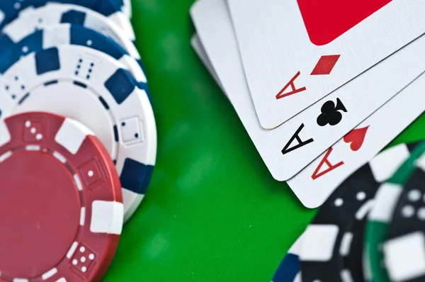 Counters and playing cards on a green background — Stock Photo, Image