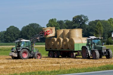 Harvesting hay with tracktor clipart