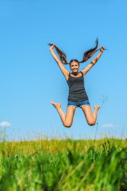 Beautiful woman jumps high into sky clipart