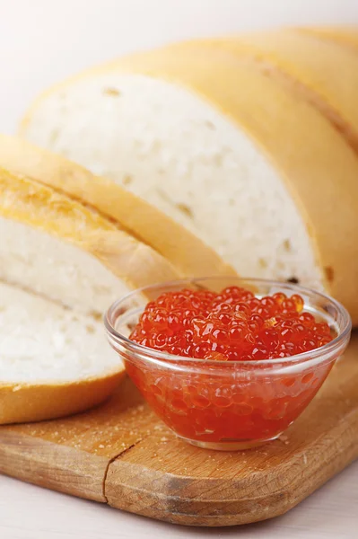 Cut loaf of white bread and caviar — Stock Photo, Image