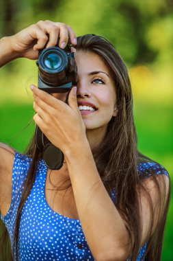 Woman photographed with camera and smiling clipart