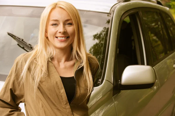 Jovem mulher sorrindo sobre o carro — Fotografia de Stock