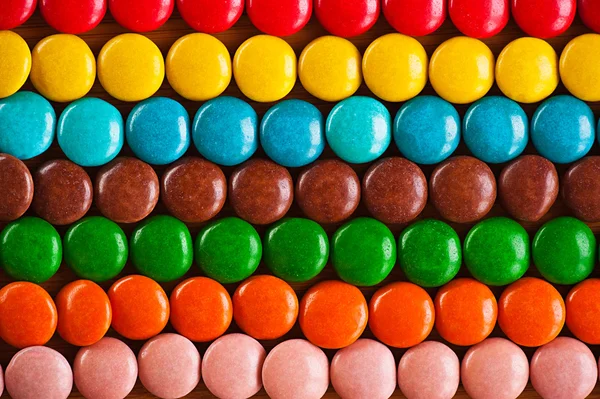 Colored, round chocolate candies in the frosting — Stock Photo, Image