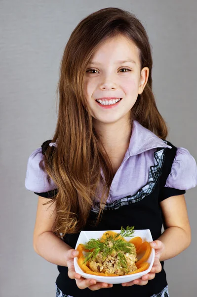 Девочка (малышка), держит тарелку с салатом — стоковое фото