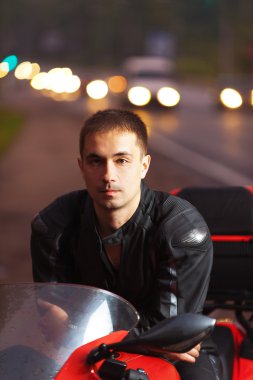 Portrait young attractive male sitting motorcyclist clipart