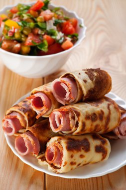 Meat rolls in the omelet, vegetable salad clipart