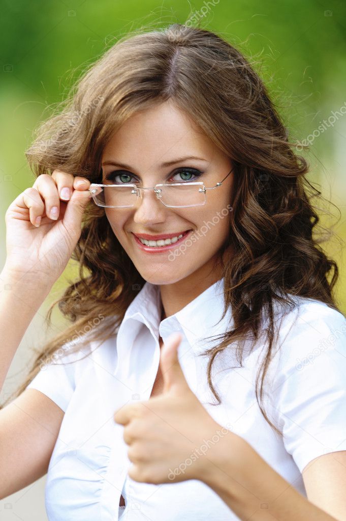 Portrait charming young woman glasses shows sign victory