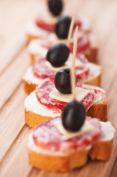 Sausage sandwiches, cheese and olives Stock Photo