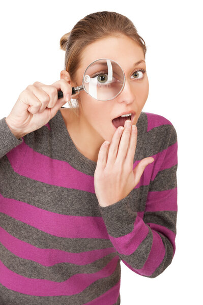 Pretty young woman with magnifier isolated on the white backgrou