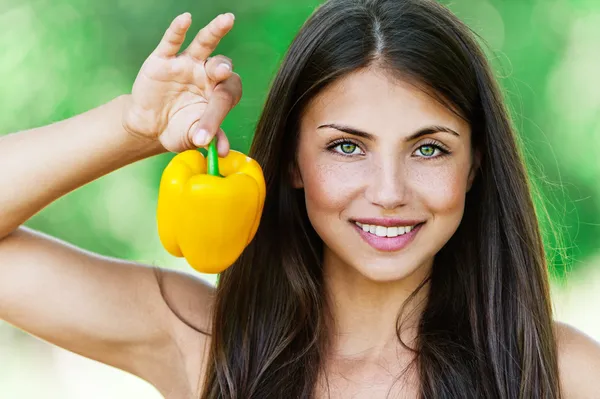 Smiling fair-haired woman holding Bulgarian pepper — Stock Photo, Image