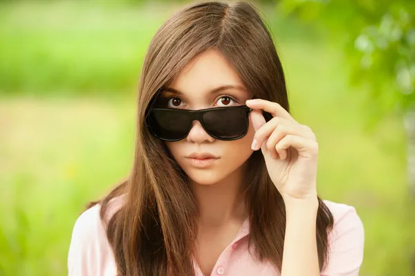 Asian woman holding her sunglasses — Stock Photo, Image