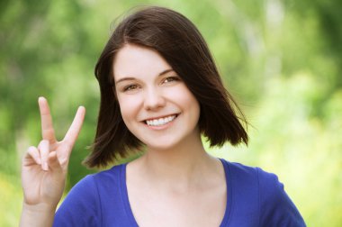 Pretty girl shows sign victory clipart