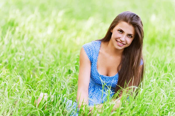 Charmante jeune femme assise herbe verte — Photo