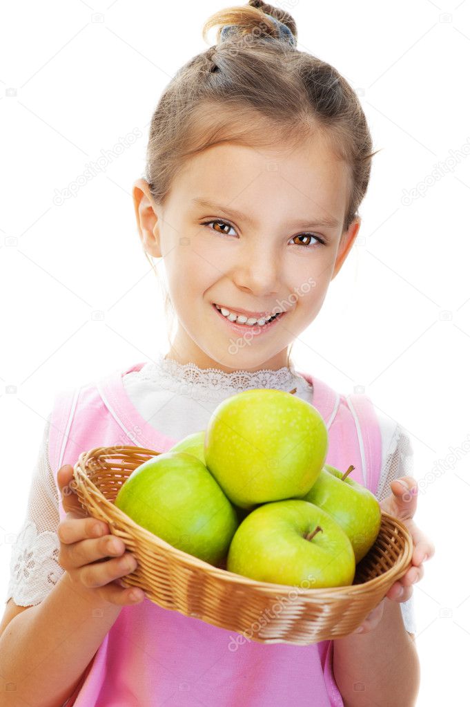 Little girl holding basket of green apples