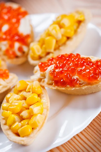 Tartlets with crab salad and corn — Stock Photo, Image