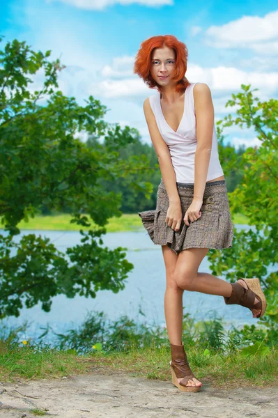 Mulher bonita de pé perto do lago — Fotografia de Stock