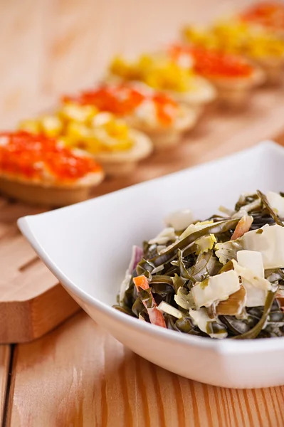 Tartlets with crab salad, corn and seaweed — Stock Photo, Image