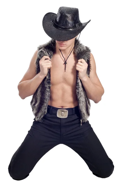 Young handsome man posing in studio in cowboy's hat — Stock Photo, Image