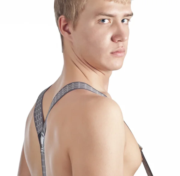 stock image Young guy posing in studio and undressing